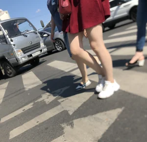 Girl in a Skirt with Sexy Skinny Legs on the Crosswalk Candid Photos
