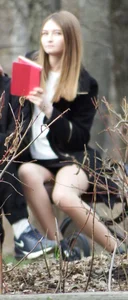 Girl Sitting on a Park Bench in Skirt and Pantyhose