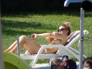 Topless lady at the pool with nice tits