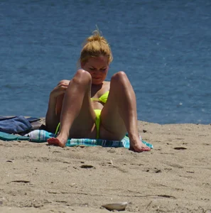 Sexy ass blonde milf on the beach in a thong with cameltoe and bending over