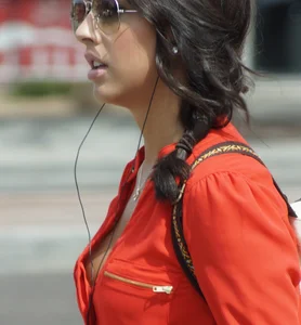 Babe in pink shorts walking showing a bit of cleavage and almost a nip slip