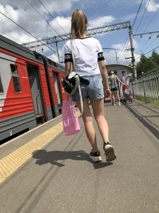 Cute Girl in Denim Shorts Walking Down a Railway Station Gallery