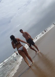 Sexy thick brunette babe in bikini on the beach