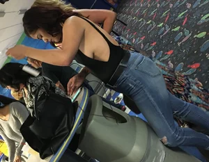 Thick brunette in tight jeans and showing some side boob