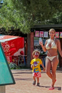 Big boobed blonde milf dancing by the pool in a bikini