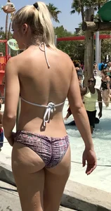Two sexy blondes at a water park with nice asses in bikinis