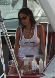 Bikini babe on a boat with a wet see through white shirt showing her tits