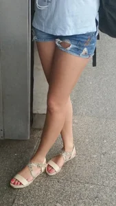 Girl in Denim Torn Mini-Shorts and Sandals in Subway Candid