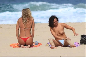 Sexy girls topless on a nude beach showing their nice tits