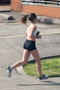 Beautiful girl out for a run in spandex shorts