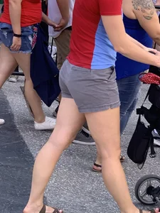 Bunch of girls in various outfits at a Cardinals baseball game