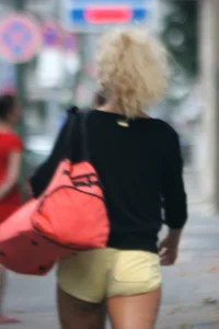 Blonde looking sexy walking in short yellow shorts