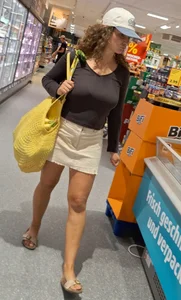 Curly haired woman with huge tits and nice legs