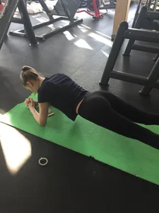 Skinny Girl in Black Yoga Pants working Out on the Yoga Mat Gym Creepshot