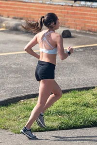 Beautiful girl out for a run in spandex shorts