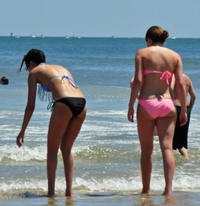 Two teen friends in bikinis at the beach