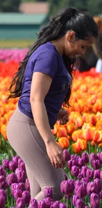 Cute babe in tight leggings taking pictures in flower fields