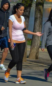 Thick lady walking in leggings with a big booty