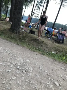 Cute Barefoot Girl in a Black Body Swimsuit Walking on a Road