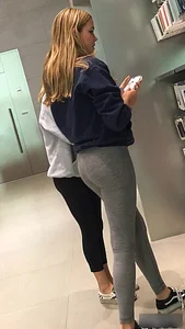 Blonde teen shopping at an Apple store in tight grey leggings