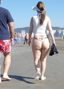 Big booty beach babe in thong bikini