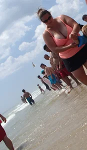 Thick lady on the beach with huge tits