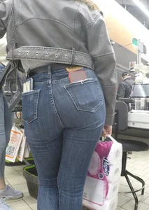 Two hot milfs in tight blue jeans standing at the cash register at the supermarket, awesome big butts