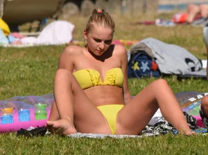 Blonde looking sexy in a yellow bikin