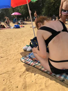 Skinny Girl in a Black Swimsuit at a Beach