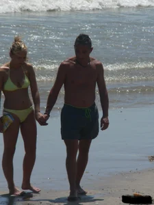Sexy blonde on the beach in a yellow thong bikini