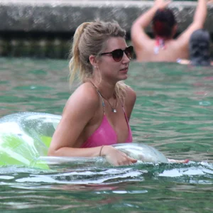 Blonde bikini girl at the pool in pink bikini top with amazing tits