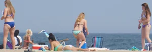 Cute girls in light blue and purple bikinis on the beach