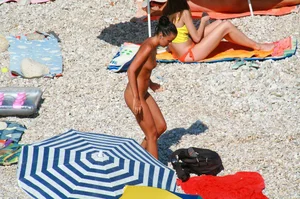 Ula FKK Sexy brunette on a nude beach topless, bottomless and with blue thong
