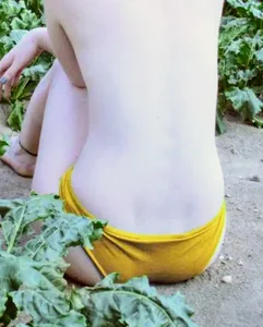 Very pale topless girl in panties sitting on the ground creepshot