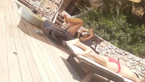 Sexy girl stretching herself while laying on sunbed
