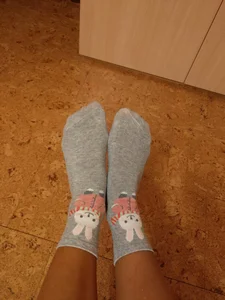 Female Feet in Socks with Bunnies Sitting on the Floor Selfie