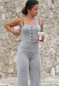 Latina with a great ass in a grey one piece outfit
