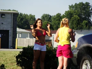 Group of cute girls at a car wash in bikinis and shorts