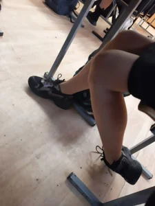 Legs of candid college teens wearing pantyhose in class