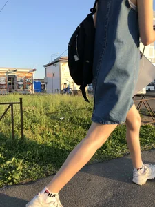 Cute Girl in Denim Dress Legs Closeup