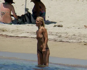 Small boobed topless milf on the beach