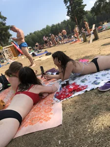 Pale Girl in Swimsuit Lying on a Lake Beach With Her Friends Creepshots Gallery