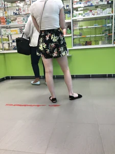 Blonde with Pale Skin in a Skirt and Sandals in the Pharmacy - Hot Legs Closeup