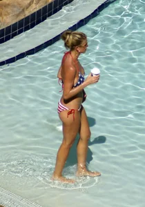 Blonde babe at the pool with sexy body in USA bikini