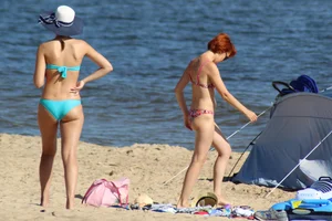 Couple of hot babes hanging out at the beach in bikinis