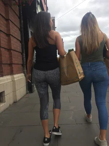 Sexy girl walking in grey patterned leggings with friend in tight jeans