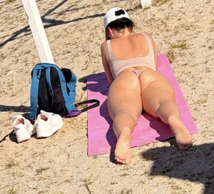 Large collection of hot beach girls lying on the beach and bending over