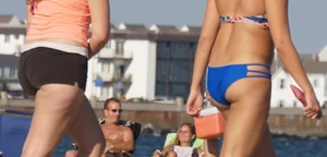 Beach babe in a blue bikini with thick friend in shorts