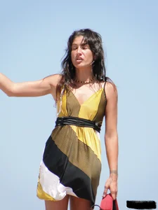 Topless lady on the beach in a gold thong with a nice ass