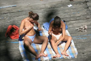 Two teens stripping and going topless to tan